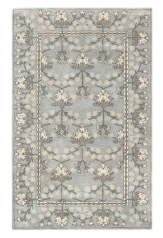 the rug is shown in grey and white with an intricate design on top of it