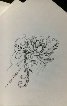 a drawing of a flower on top of some white paper with black and grey ink