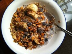 a bowl filled with oatmeal and nuts on top of a table