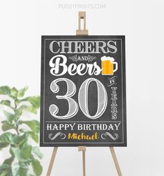 a chalkboard sign with the words cheers and beers on it next to a potted plant