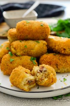 some fried food on a white plate with parsley