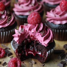 chocolate cupcakes with raspberry frosting and fresh raspberries on top