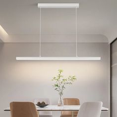 a dining room table with chairs and a vase on it