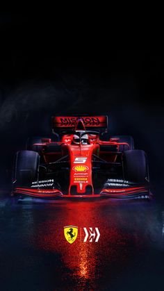 a red race car is shown in the dark