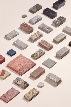 a group of different colored rocks on a white surface