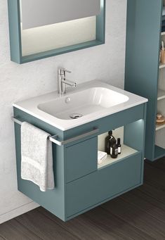 a bathroom sink sitting under a mirror next to a cabinet