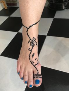 a woman's foot with a tattoo on it