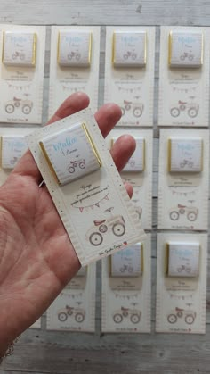 a person holding up a small card in front of many cards with bicycles on them