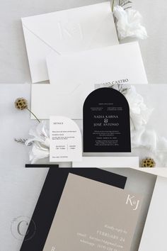 the wedding stationery is laid out on top of each other