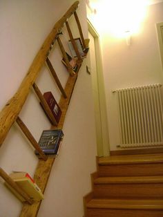 there is a wooden ladder with books on it