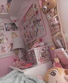 a small child's bedroom with pink walls and stuffed animals on the shelves above