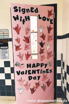 a pink door decorated with handprints and the words, signed with love happy valentine's day