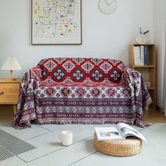 a living room with a couch covered in a blanket