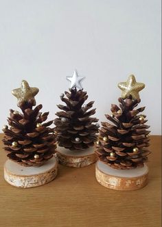 three pine cones with gold decorations on them