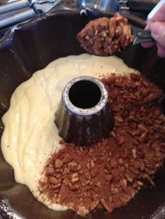 someone is mixing something in a bowl with chocolate and other things to make it look like they're cooking