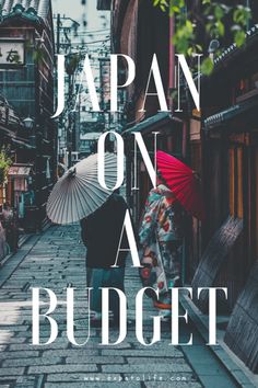 two people walking down the street with umbrellas over their heads, japan on a budget