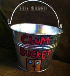 a metal bucket with the words chum bucket written in red and blue on it