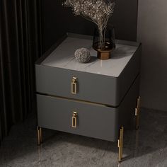 a gray and gold box with flowers on top