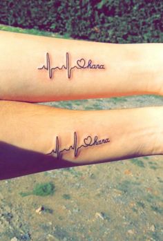 two people with matching tattoos on their arms