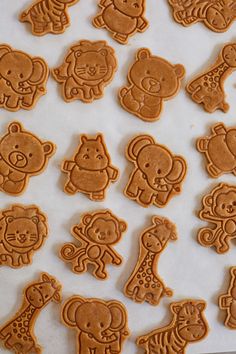 some cookies are shaped like animals and giraffes on a sheet of paper