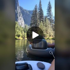 a boat floating on top of a lake next to a forest