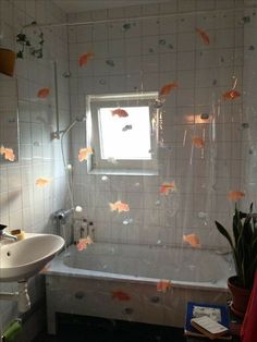 a bathroom with fish on the wall and bathtub