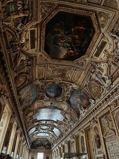 an ornate hallway with paintings on the ceiling