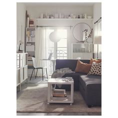 a living room filled with furniture and lots of white shelves on top of each other