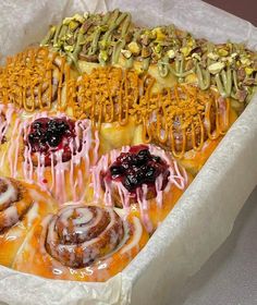 a tray filled with different types of pastries and toppings on top of each other