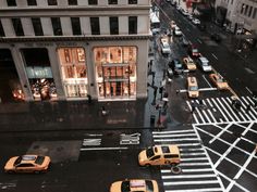 taxi cabs and pedestrians crossing the street in new york city, ny at night