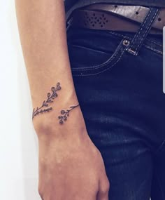 a woman's arm with a small tattoo on the left side of her wrist