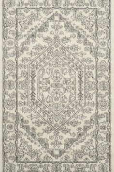 a rug with an intricate design on the bottom and sides, in black and white