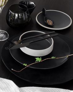 black and white plates with silverware on them