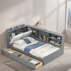 a bed with drawers underneath it in a room