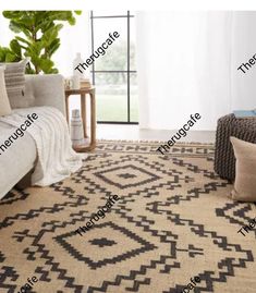 a living room area with a couch, chair and rug on the floor in front of a window