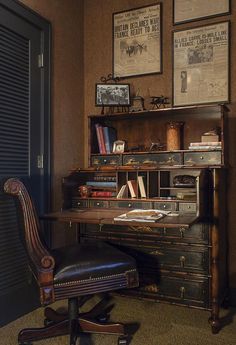 an old fashioned desk and chair in a room