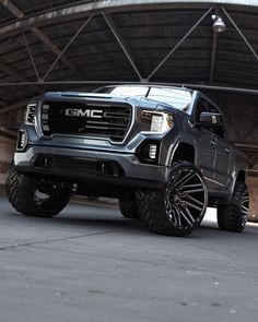 a gray truck parked in front of a large building