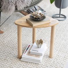 a wooden table with books on it in a living room