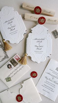 the wedding stationery is laid out with stamps and envelopes