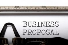 an old typewriter with the words business proposal written on it