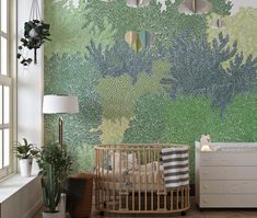 a baby's room with a crib and green wallpaper