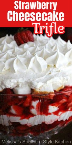 strawberry cheesecake trifle in a glass dish with whipped cream and raspberries