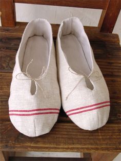 pair of white shoes sitting on top of a wooden chair