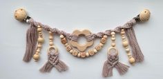 an assortment of wooden beads and tassels on a white background with the word love spelled in large letters