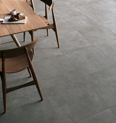 a dining room table with chairs and a tray of food on it's side