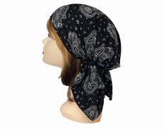 a woman's head wearing a black bandana with white paisley designs on it