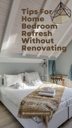 a white bed sitting under a wooden ceiling