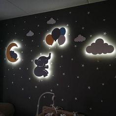 the wall is decorated with stars, clouds and an elephant on it's head