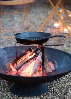 an outdoor fire pit sitting on top of gravel