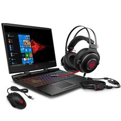 a laptop computer with headphones, mouse and headset